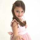 Girl with long hair wearing glitter ballet shoe hair clips on a white background