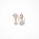 Photo of two kids’ hair clips with silver glitter star accents attached to soft blush-pink oval bases, displayed on a white card with a small gold heart.