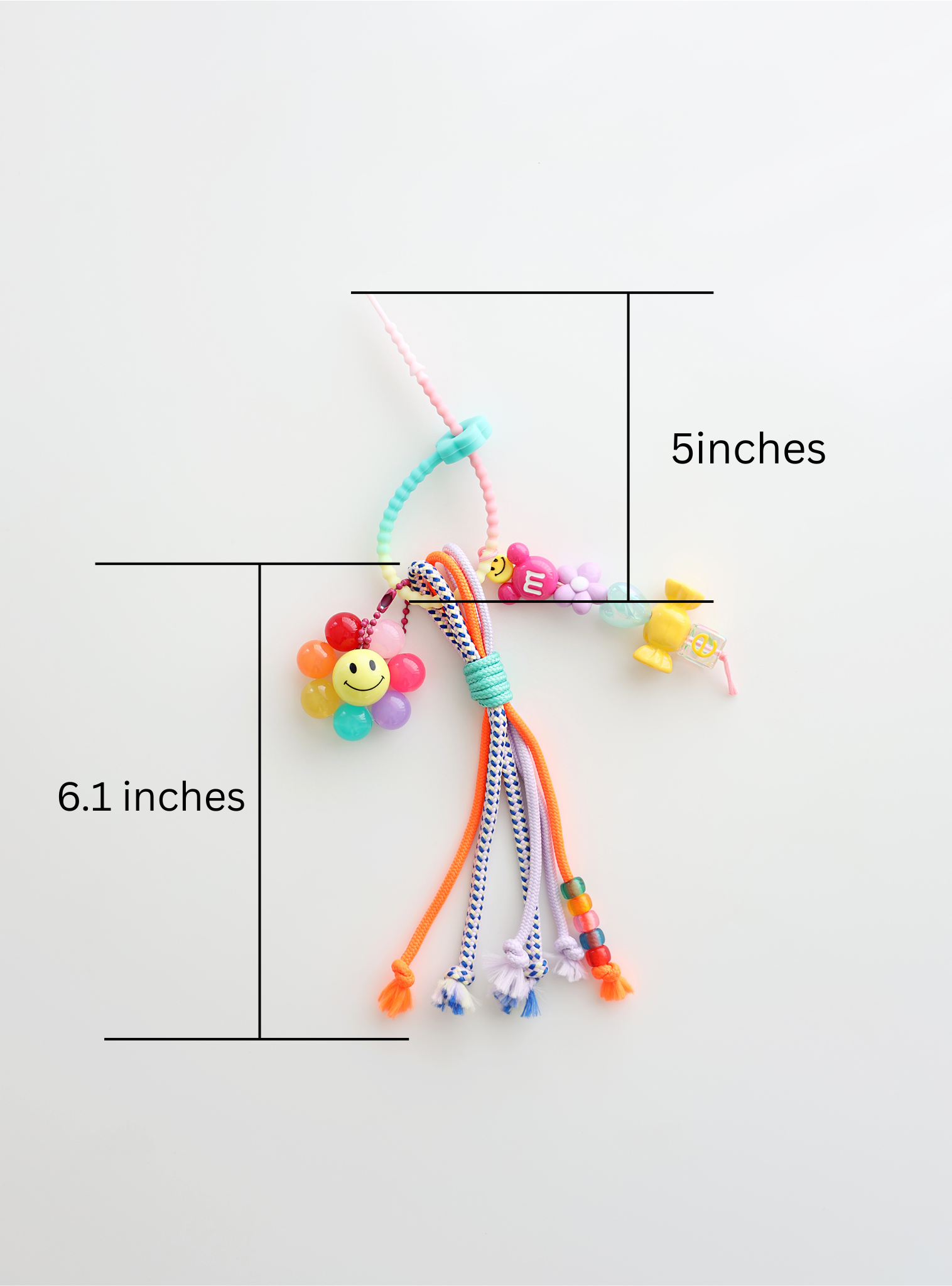 Colorful bag charms with beads and a smiley flower placed on a white background with measurement which is 5inches of the top holder part and 6.1inches of the body of bag charm