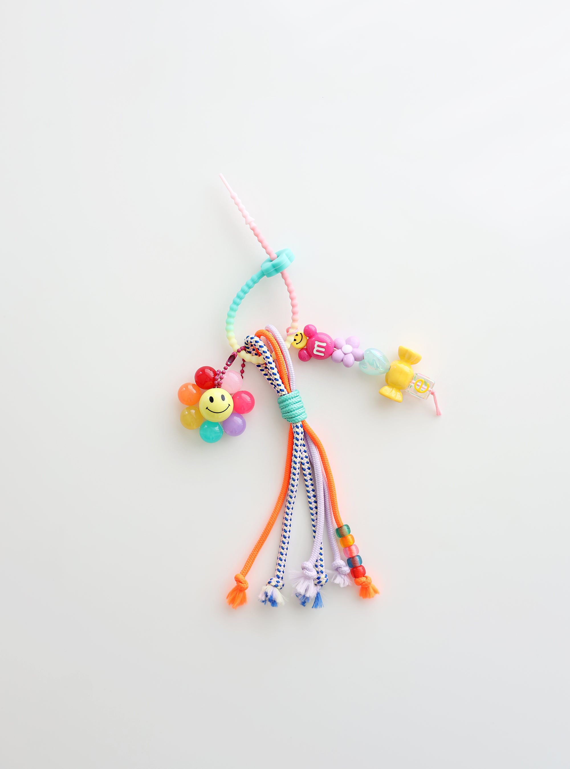 Colorful beaded keychain with smiley face on a white background
