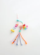 Colorful beaded keychain with smiley face on a white background