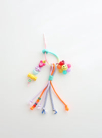 Colorful beaded keychain with smiley face on a white background