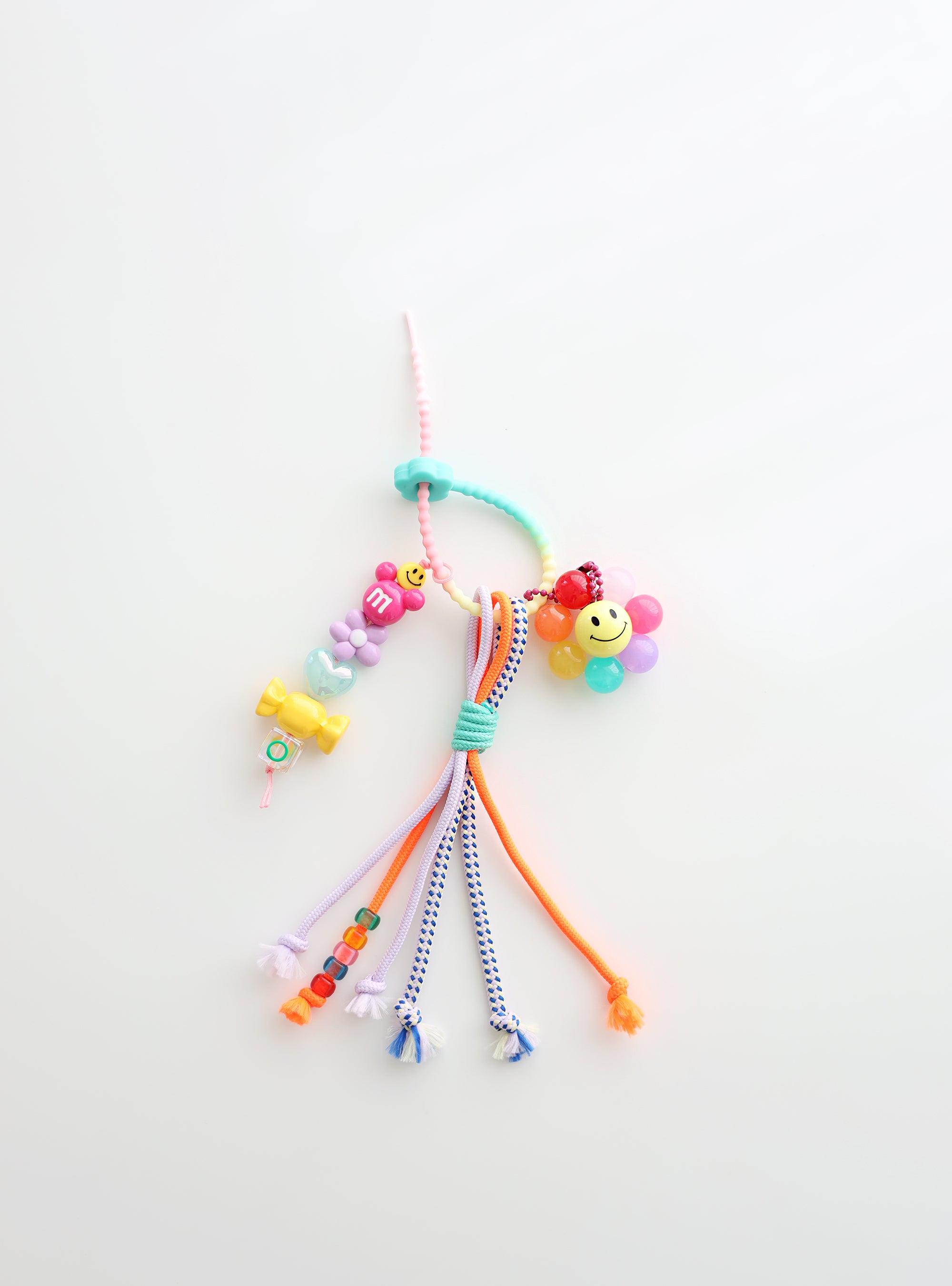 Colorful beaded keychain with smiley face on a white background