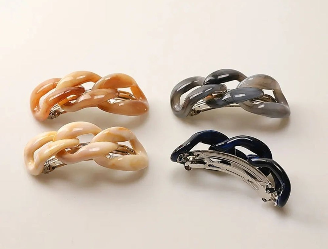 Four hair clips (Brown, Beige, Navy, Grey) with a chain-link design on a white background.