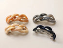 Four hair clips (Brown, Beige, Navy, Grey) with a chain-link design on a white background.