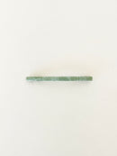One slim rectangular hair clip in marbled shades of jade neatly displayed on a white surface.