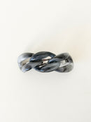 Gray marbled hair clip on a white background.