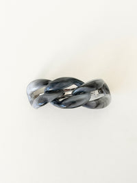 Gray marbled hair clip on a white background.