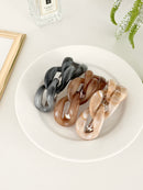 Three hair clips (Brown, Beige, Grey) with a chain-link design on a white plate in a white background.