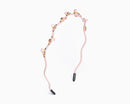 a hairband with branch-like design and small crystal in light pink color.