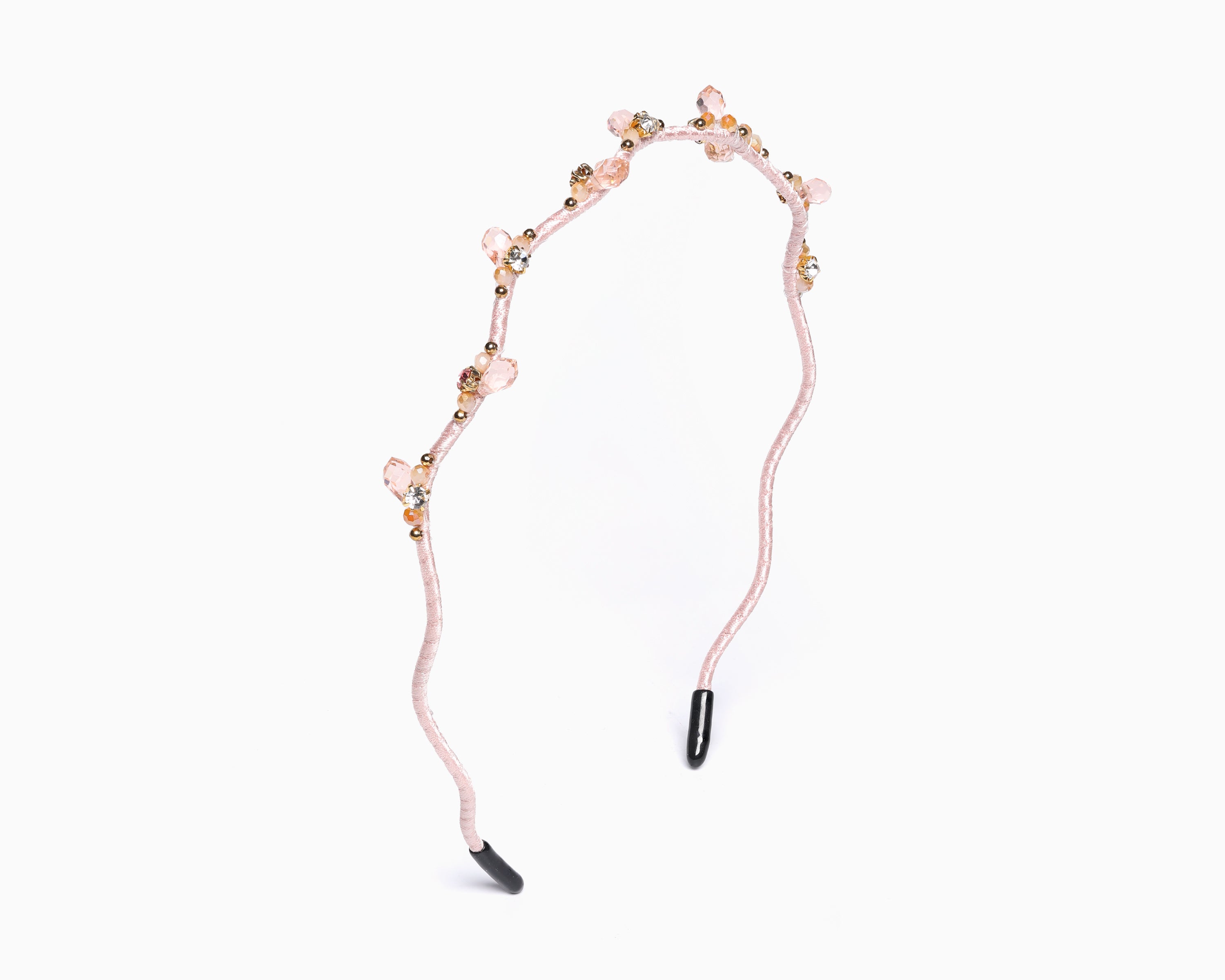 a hairband with branch-like design and small crystal in light pink color.